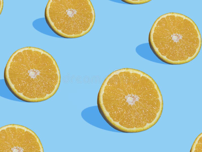 Fresh orange slices on blue background with shadow , top view