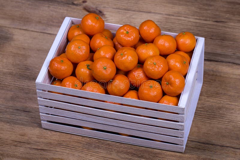 Fresh orange, tangerine fruit, mandarin pattern background in a wooden box . Concept of healthy, organic, vegan food stock photos Fresh orange, tangerine fruit, mandarin pattern background in a wooden box . Concept of healthy, organic, vegan food stock photos