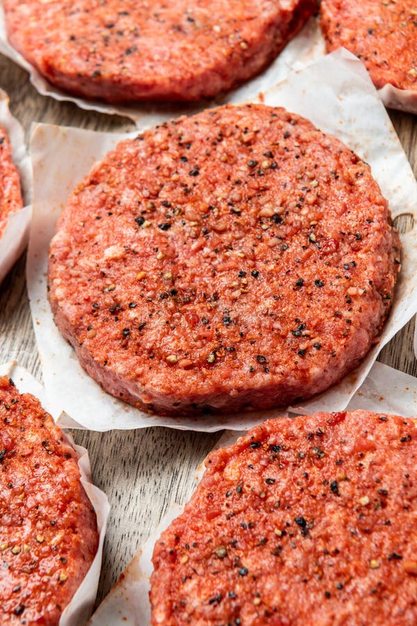Raw Patty for Angus Burger on Wooden Cutting Board. Patty for Burger