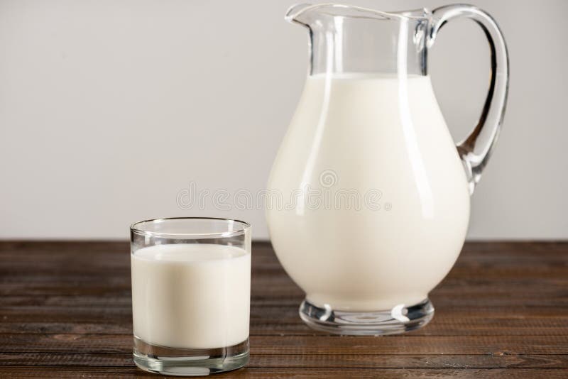 Fresh Organic Milk In Glass Jug And Glass On Wooden Table Top