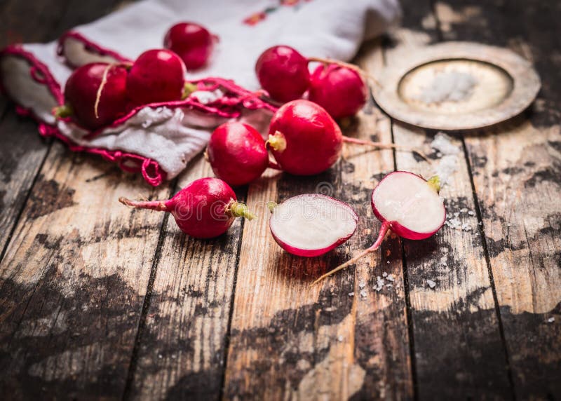 Fresh organic radish with salt on rustic kitchen table. Simple food royalty free stock images Fresh organic radish with salt on rustic kitchen table. Simple food royalty free stock images