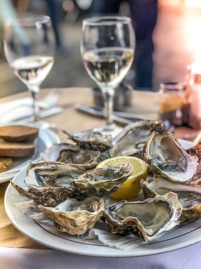 Fresh Oysters Served on a Table in Summer Restaurant Stock Photo