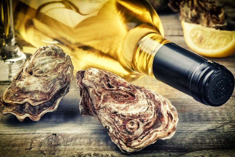 Oysters in a White Plate with Lemon and a Glass of Wine on a Wooden Table Stock Image Image of
