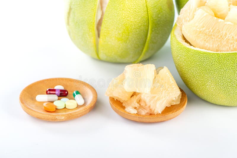 Fresh Peeled Pomelo, Grapefruit, Shaddock with Green Leaves on Dark Wooden Plank Table. Seasonal