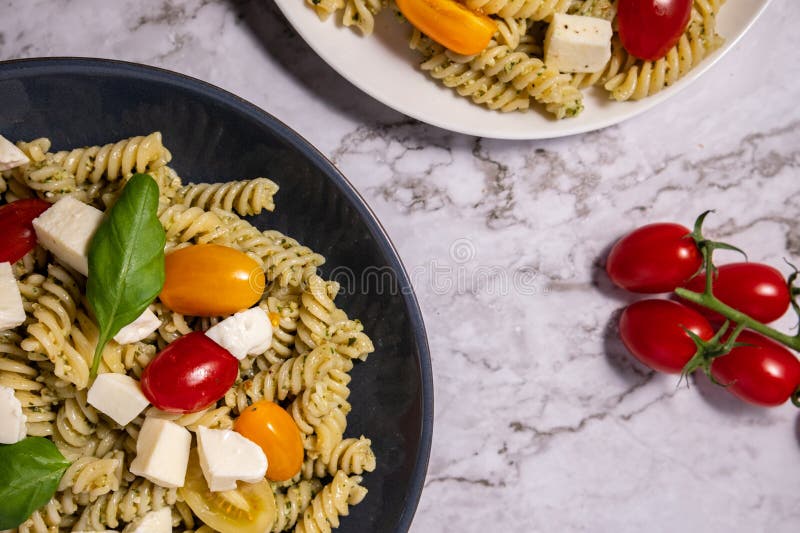 Fresh Pesto Pasta Salad with Tomatoes and Mozzarella Stock Photo