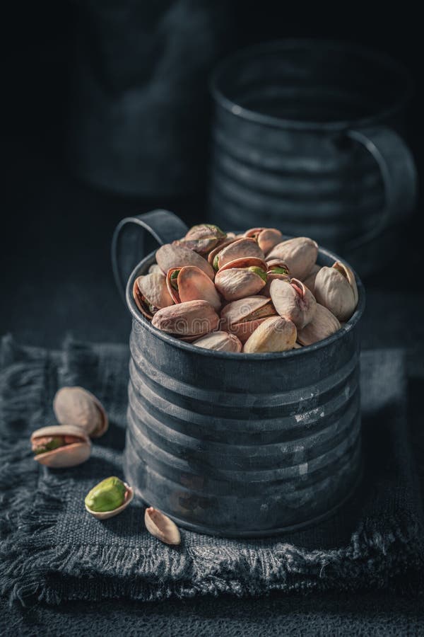 Fresh Pistachios on Dark Table. Quick and Good Snack Stock Photo