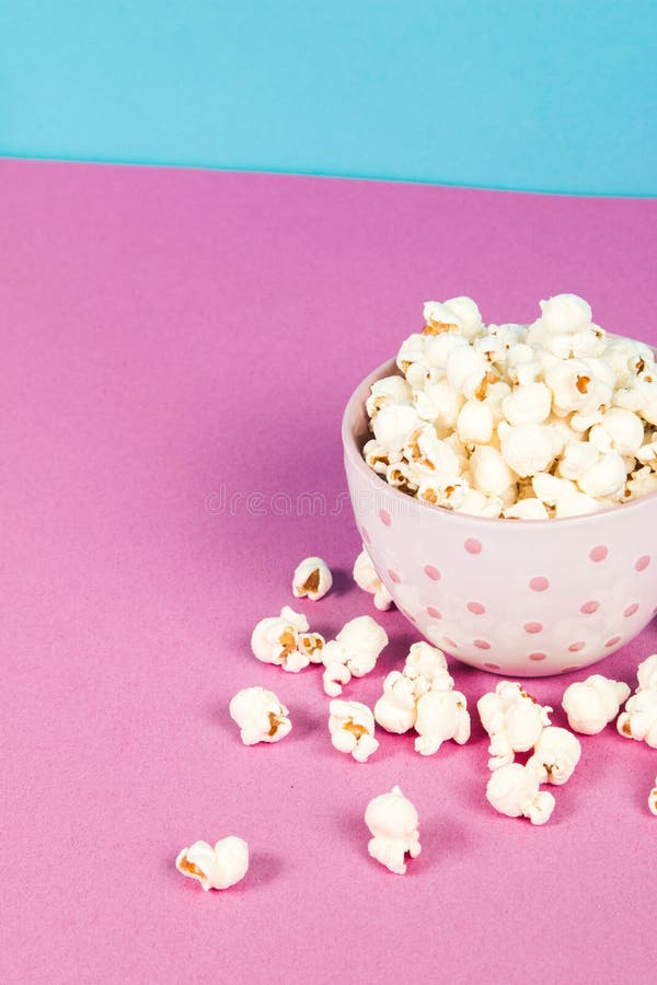 Fresh Popcorn in a White Pink Bowl on Pink and Blue Background with the