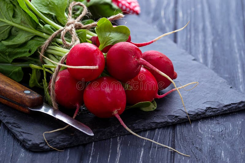 Fresh radishes and knife