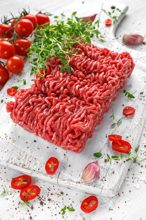 Fresh Raw Beef Minced Meat with Salt, Pepper, Chilli and Fresh Thyme on ...