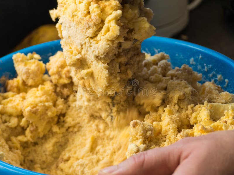 Fresh raw Dough in a Bowl with Hands royalty free stock image.
