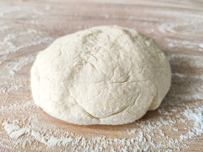 Fresh raw dough on wooden table covered with flour. Top view. Raw fresh yeast dough stock images, royalty-free photos and pictures