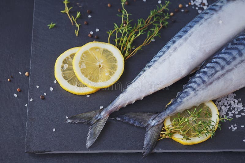 Fresh Raw Fish Mackerel and Ingredients for Cooking on a Dark Ba Stock