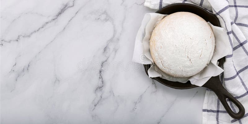 Fresh raw homemade yeast dough resting in cast iron skillet on marble table flat lay. Raw fresh yeast dough stock images, royalty-free photos and pictures
