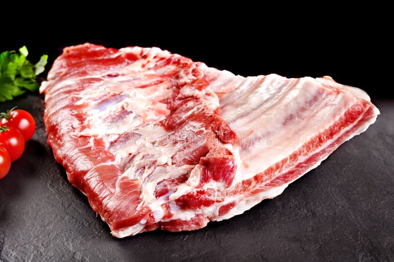 Fresh and raw meat. Ribs and pork chops uncooked, uncut ready to grill and barbecue. royalty free stock image Fresh and raw meat. Ribs and pork chops uncooked, uncut ready to grill and barbecue. royalty free stock image