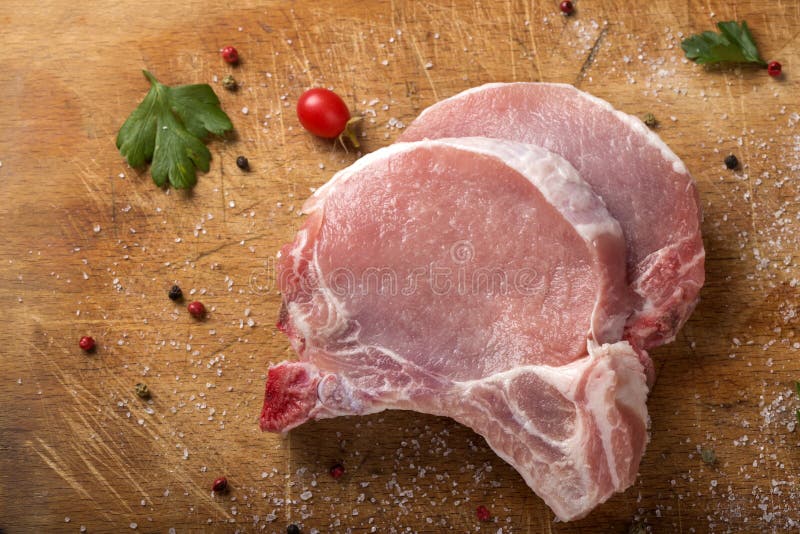 Fresh raw pork chops on a cutting board