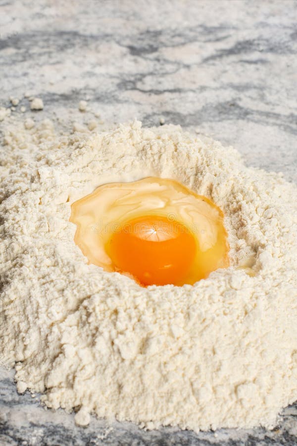 Fresh Raw Smashed Egg in the White Flour Pile Stock Photo Image of