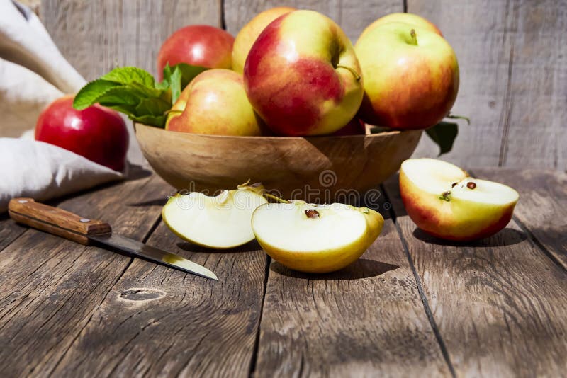 Fresh red apples with green leaves on a wooden old table. On a wooden background. royalty free stock photo Fresh red apples with green leaves on a wooden old table. On a wooden background. royalty free stock photo