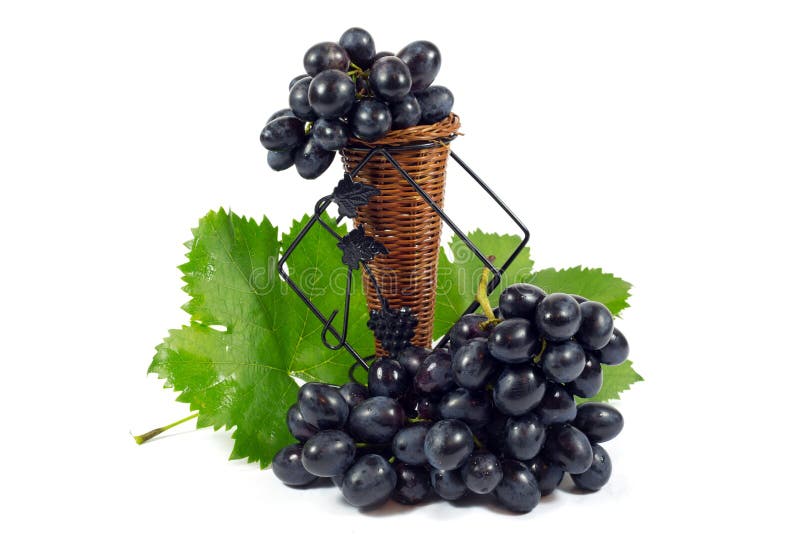 Fresh Red Grapes with Green Leaves in Wicker Basket Isolated on White