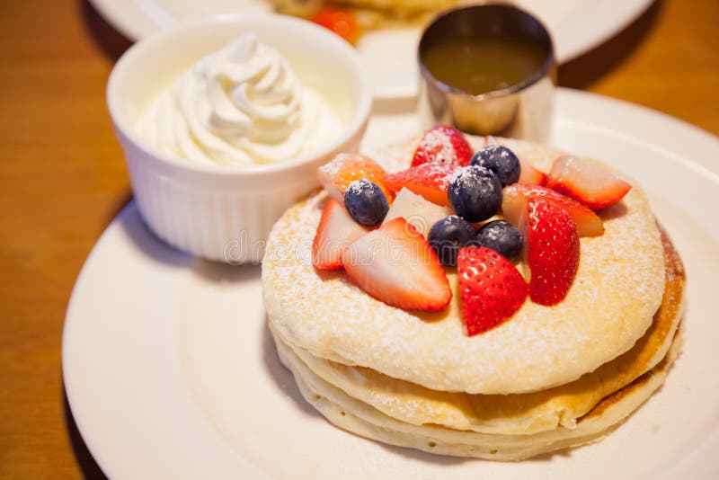 Fresh red strawberries and blackberries fruit toppings on pancake seasoned with whipped cream. Healthy sweets, desserts, snack, stock images Fresh red strawberries and blackberries fruit toppings on pancake seasoned with whipped cream. Healthy sweets, desserts, snack, stock images