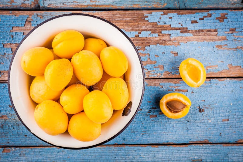 Fresh ripe organic apricots in bowl above view