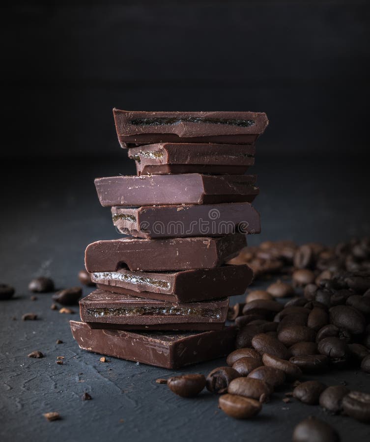Fresh Roasted Coffee Beans and Stack of Brown Chocolate. Stock Photo