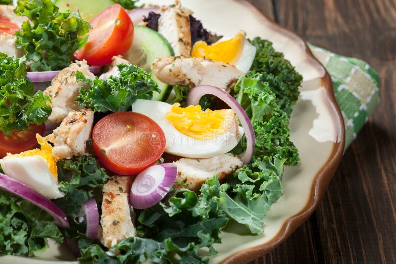 Fresh Salad with Chicken, Tomatoes, Eggs and Lettuce on Plate Stock ...