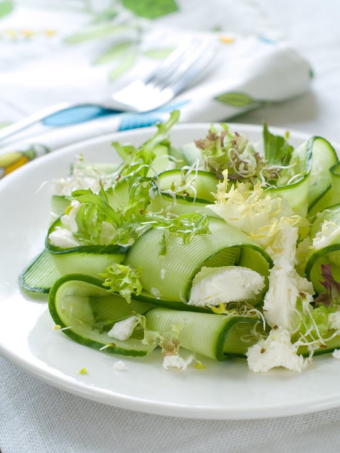 Fresh salad of cucumber, lettuce and goat cheese, selective focus