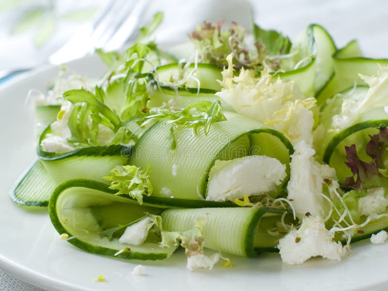 Fresh salad of cucumber, lettuce and goat cheese, selective focus