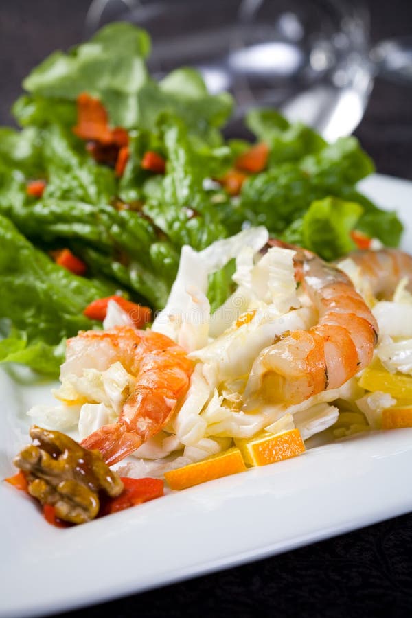 Fresh salad with shrimps and walnuts royalty free stock photo