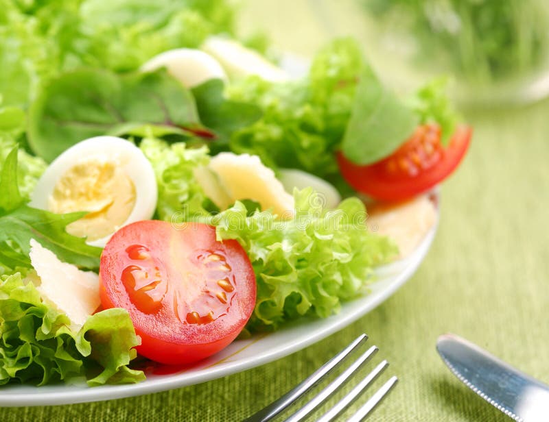 Fresh salad with tomato and quail eggs