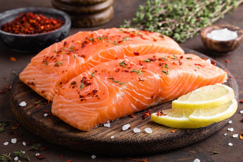 Fresh salmon fish fillet on wooden board