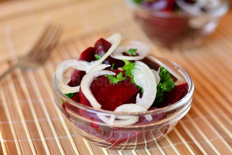 Fresh Sliced Beetroot Salad with Onion and Parsley on a Glass Bowl