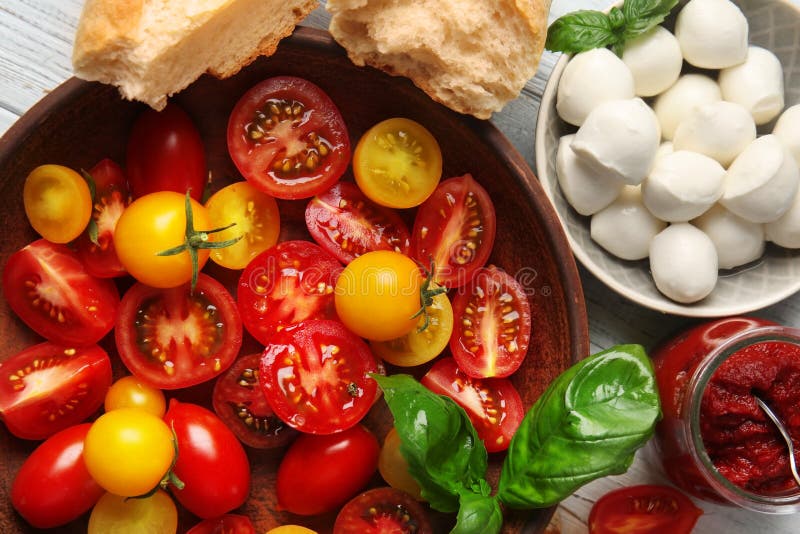 Fresh sliced cherry tomatoes on plate, closeup