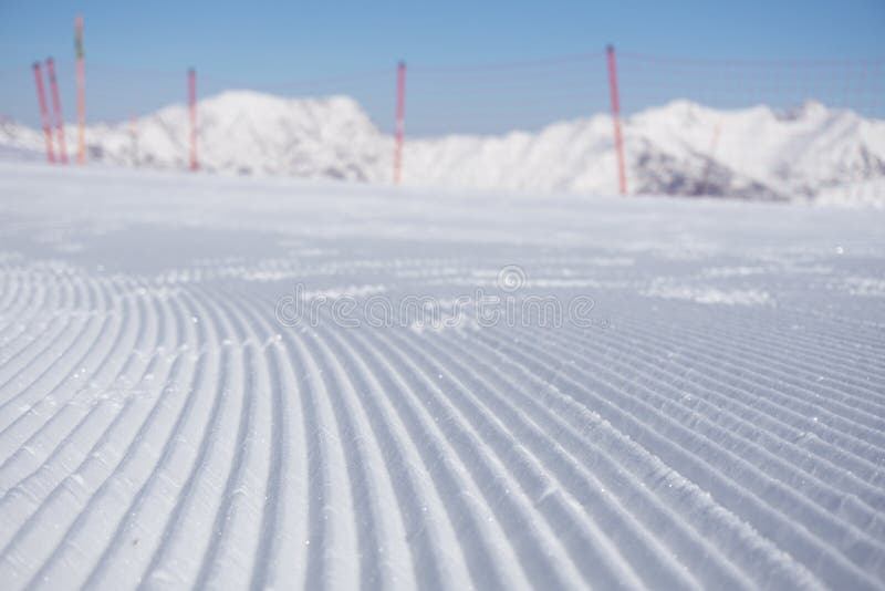 Fresh snow groomer tracks on a mountain ski piste. Fresh snow groomer tracks on a mountain ski piste