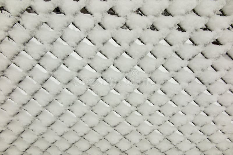 Fresh snow on metal mesh royalty free stock photos Fresh snow on metal mesh royalty free stock photos