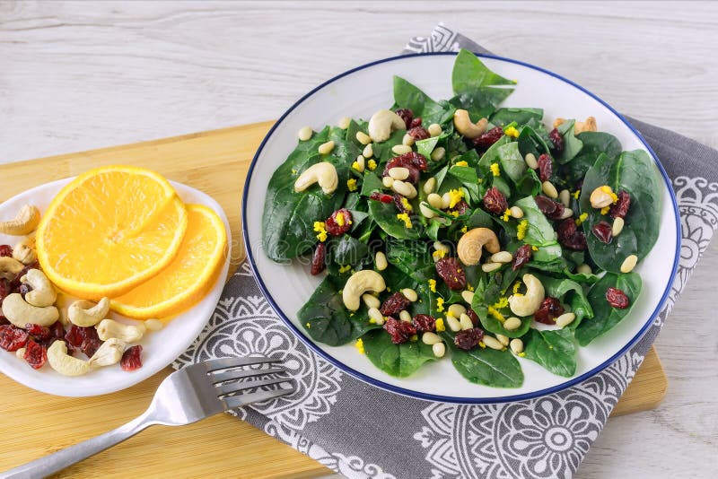 Fresh Spinach Salad with Dried Cranberries and Nuts for a Healthy Diet