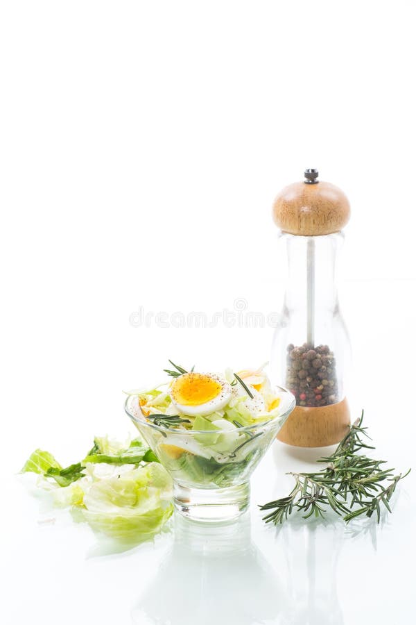 Fresh spring salad with cabbage, lettuce and boiled eggs with rosemary and spices royalty free stock photo Fresh spring salad with cabbage, lettuce and boiled eggs with rosemary and spices royalty free stock photo