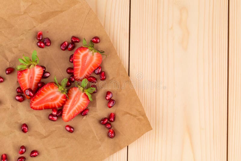 Fresh strawberries with grains of pomegranate