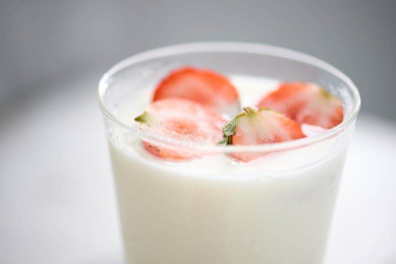 Fresh strawberry on a glass with dessert yogurt and strawberry  on white background