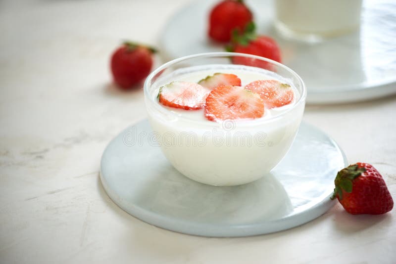 Fresh strawberry on a glass with dessert yogurt and strawberry  on white background