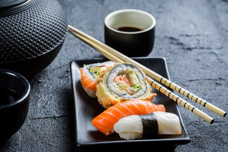 Fresh sushi served in with tea