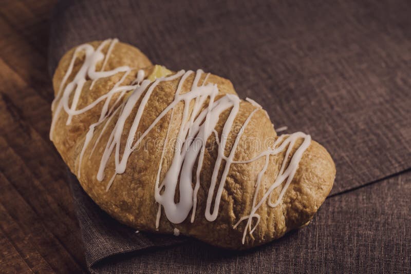 Fresh and tasty croissant with cream selective focus, delicious breakfast on brown napkin royalty free stock images Fresh and tasty croissant with cream selective focus, delicious breakfast on brown napkin royalty free stock images
