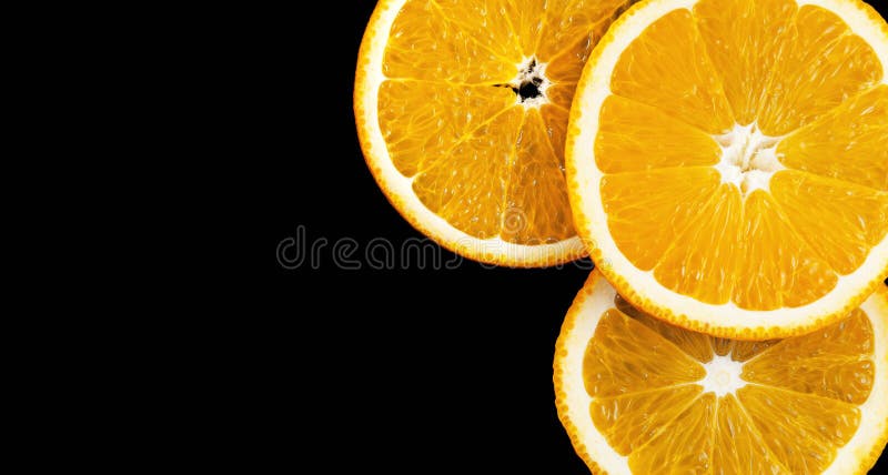 Fresh three orange slices on a black background. Panorama. stock photography