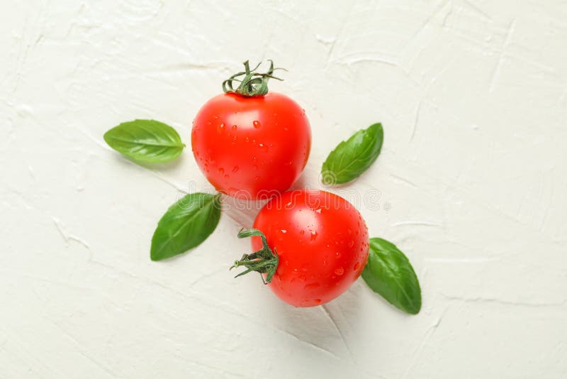 Fresh tomatoes and basil on white background, space for text and closeup