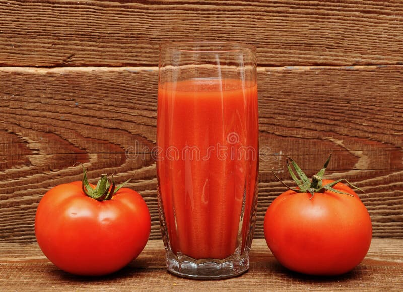 Fresh tomatoes and a glass full of tomato juice