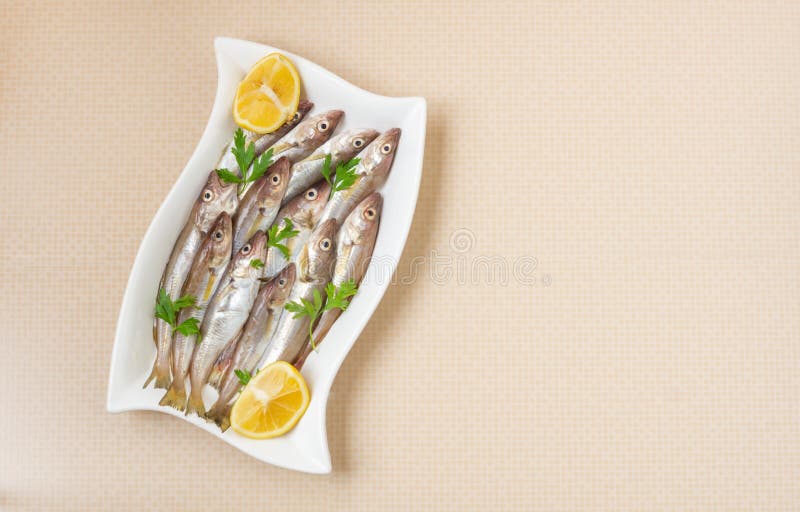 Fresh Uncooked Haddock Fishes on in Ceramic Dish on Table Stock Image