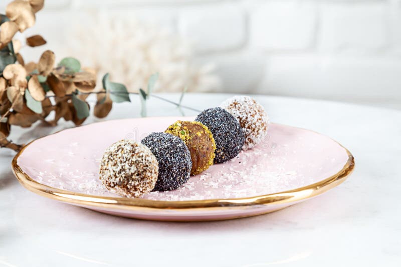 Fresh vegan raw dessert snacks. natural candies. homemade energy balls. vegan chocolate truffles candy dessert on marble table stock photo Fresh vegan raw dessert snacks. natural candies. homemade energy balls. vegan chocolate truffles candy dessert on marble table stock photo