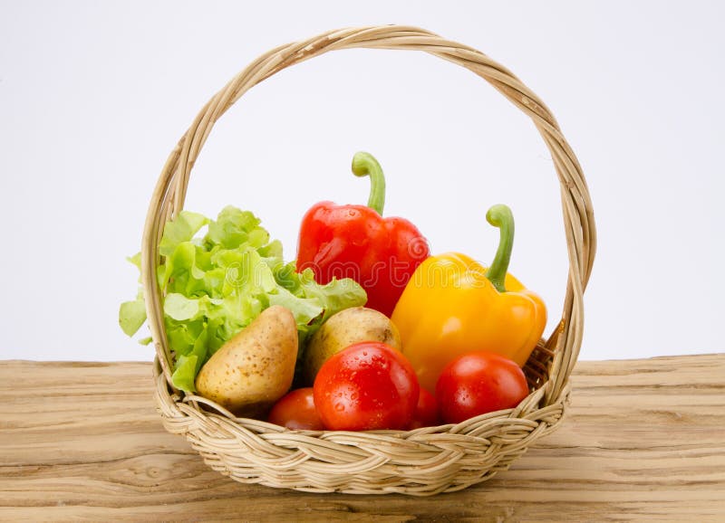 Fresh vegetable in basket on wood desk