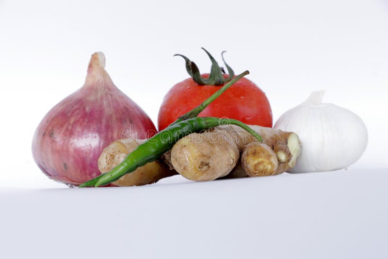 Fresh Vegetable Onion Tomato Ginger Garlic Green Chilly on White