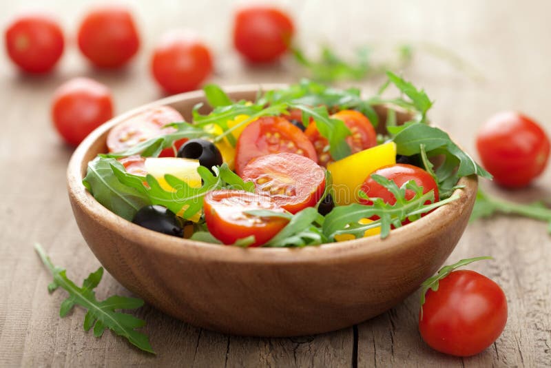 Fresh vegetable salad in wooden bowl